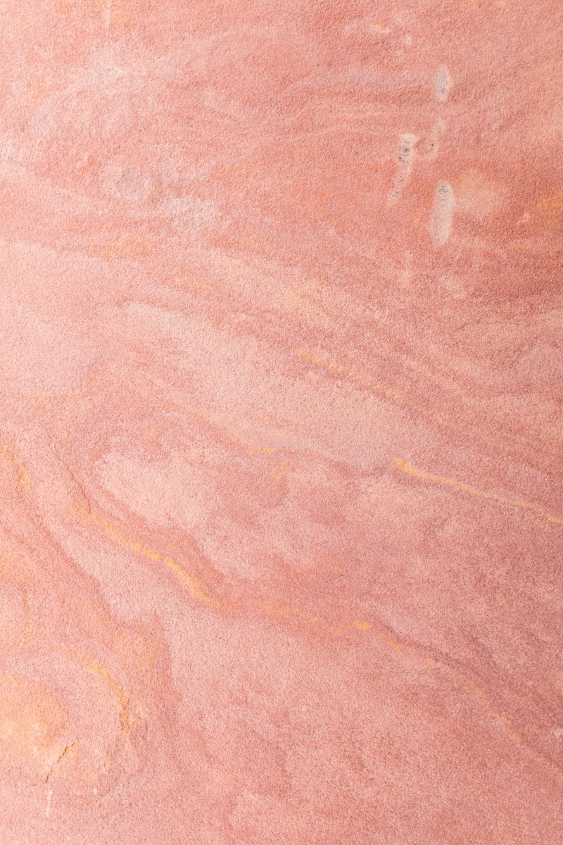 a skateboarder is riding on a pink surface